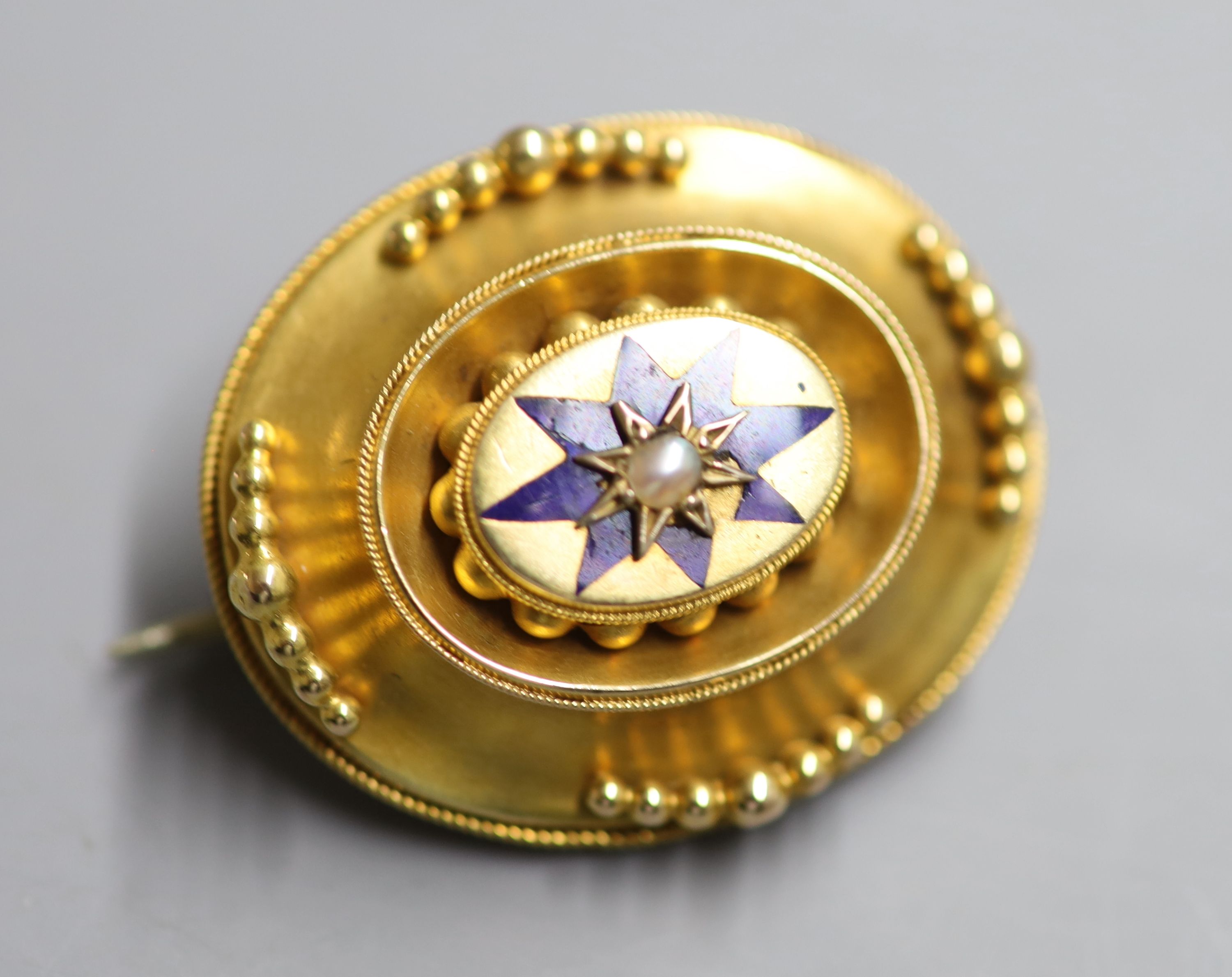 A Victorian yellow metal ,enamel and split pearl set oval mourning brooch, 32mm, gross 8.1 grams.